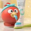 Squeeze Buddies toothpaste dispenser with a toothbrush on a light background
